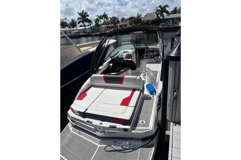 Slide: The Image of 2016 Regal 27 FasDeck RX boat docked, featuring sleek design and comfortable seating. - 13