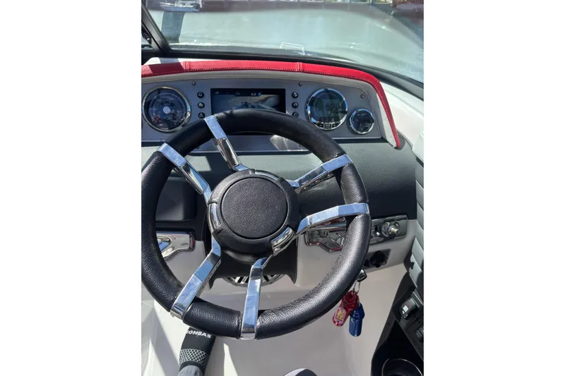 Slide: The Image of Steering wheel and dashboard of a 2016 Regal 27 FasDeck RX boat. - 16