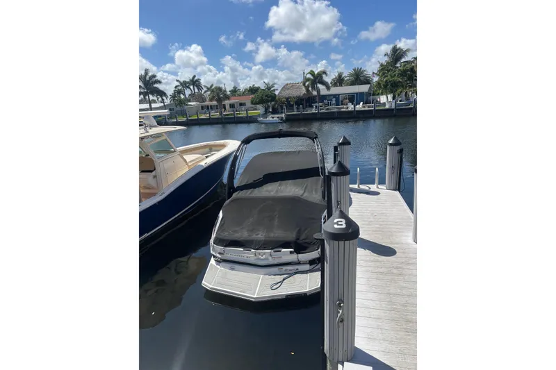 Slide: The Image of 2016 Regal 27 FasDeck RX boat docked at marina under clear skies. - 17