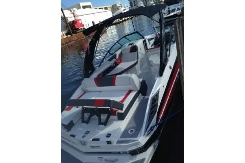 Slide: The Image of 2016 Regal 27 FasDeck RX boat docked, featuring sleek design and spacious seating. - 2