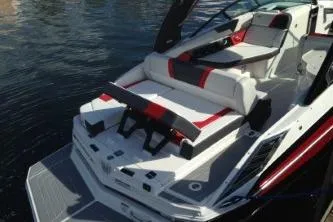 Slide: The Image of 2016 Regal 27 FasDeck RX boat with sleek design and comfortable seating on water. - 4