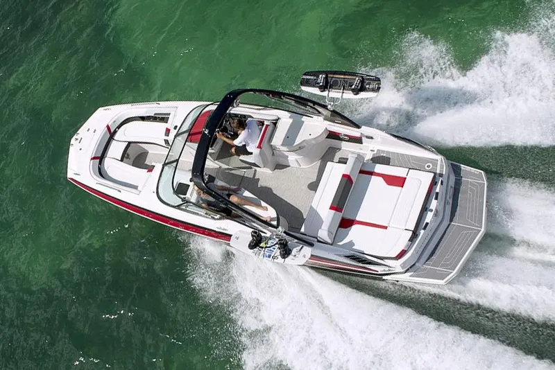 Slide: The Image of Manufacturer Provided Image: 2016 Regal 27 FasDeck RX boat cruising on green water. - 7