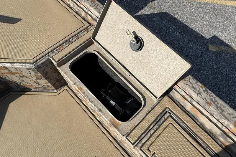 Slide: The Image of Open storage compartment on 2026 Xpress X18DB boat deck. - 10