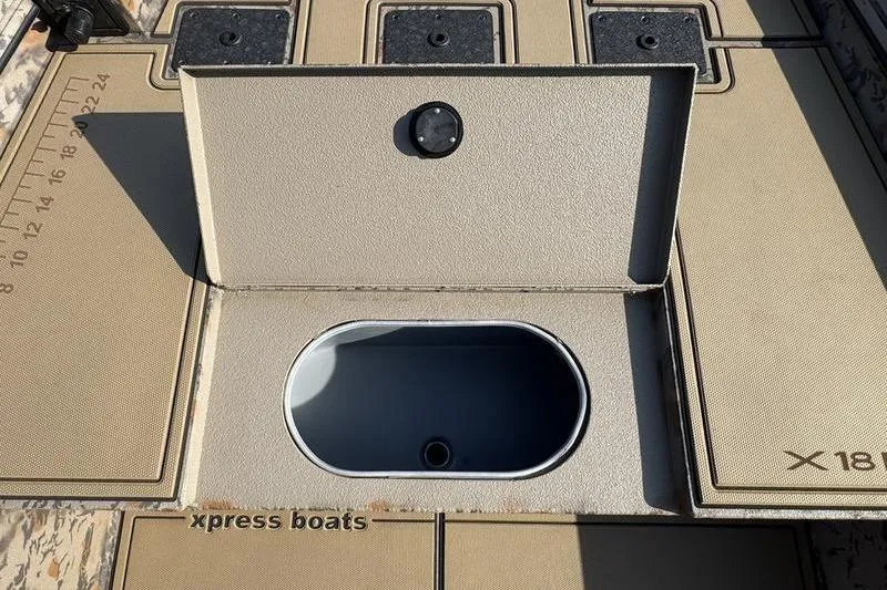 Slide: The Image of 2026 Xpress X18DB boat deck with open storage compartment and measurement markings. - 12