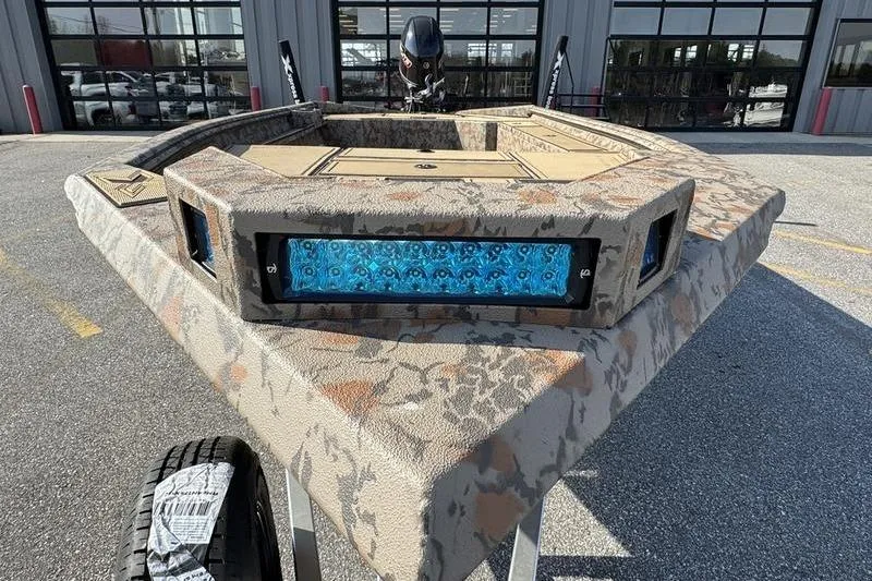 Slide: The Image of 2026 Xpress X18DB boat with camouflage design and blue LED lights. - 6