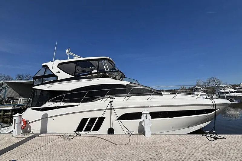 The Image of 2015 Sea Ray 510 Fly yacht docked under clear blue sky. - 0