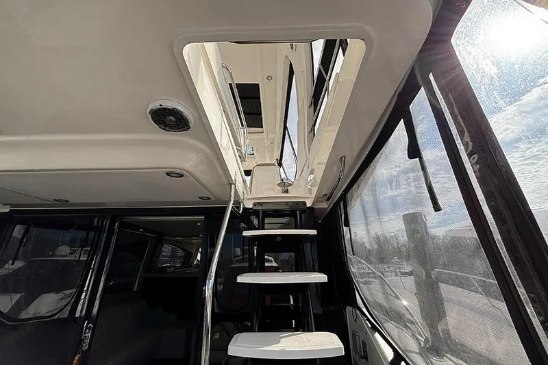 Slide: The Image of Interior view of 2015 Sea Ray 510 Fly yacht with stairs and windows. - 10