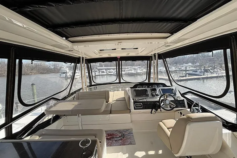 Slide: The Image of Interior view of 2015 Sea Ray 510 Fly yacht with helm and seating area. - 11