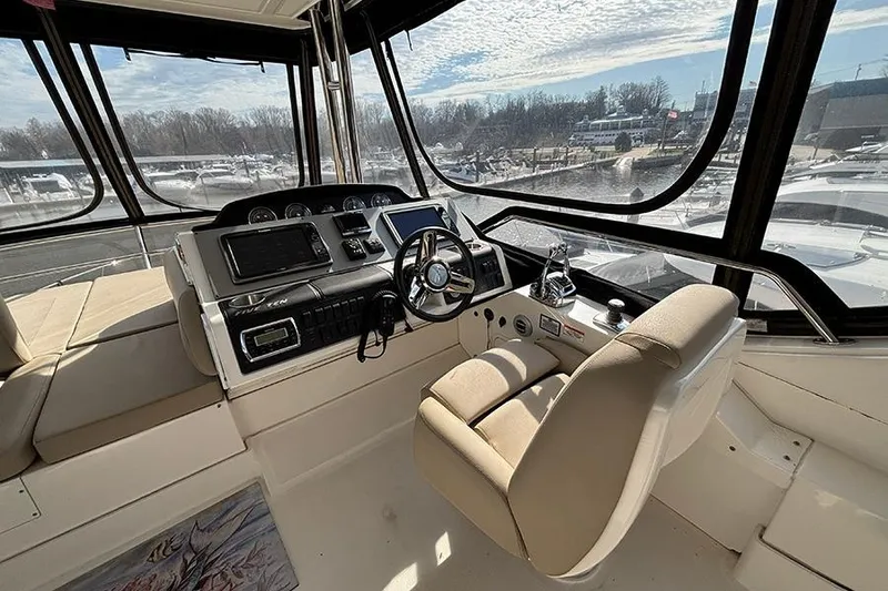 Slide: The Image of Interior helm of 2015 Sea Ray 510 Fly yacht with modern controls and panoramic windows. - 12