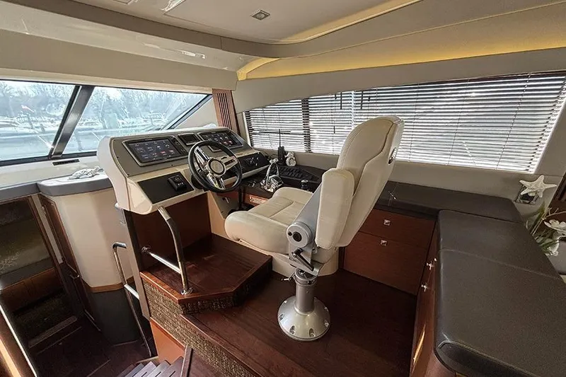 Slide: The Image of Luxurious helm of 2015 Sea Ray 510 Fly yacht with modern controls and plush seating. - 21