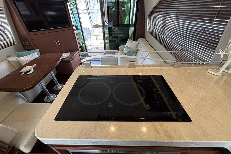 Slide: The Image of Luxurious interior of 2015 Sea Ray 510 Fly yacht with modern kitchen and seating area. - 26