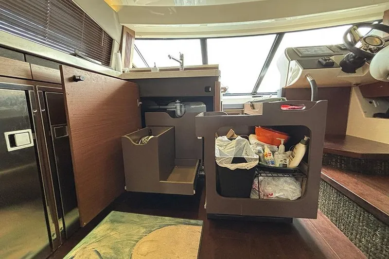 Slide: The Image of Interior of 2015 Sea Ray 510 Fly yacht kitchen with open cabinets and storage. - 29