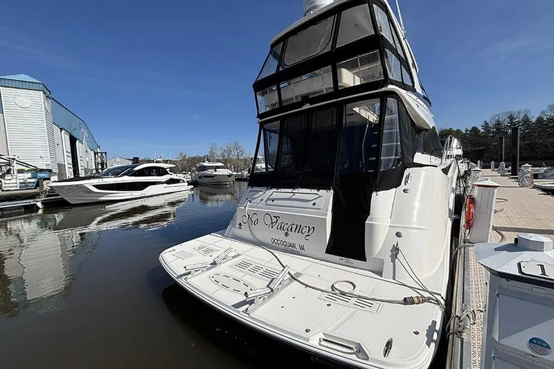 Slide: The Image of 2015 Sea Ray 510 Fly yacht docked at marina, clear blue sky. - 3