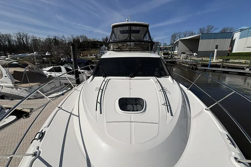 Slide: The Image of 2015 Sea Ray 510 Fly yacht docked at marina under clear blue sky. - 4