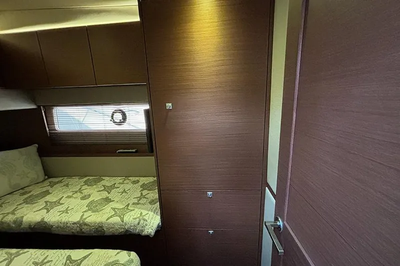 Slide: The Image of Interior cabin of 2015 Sea Ray 510 Fly yacht with twin beds and wooden cabinetry. - 43