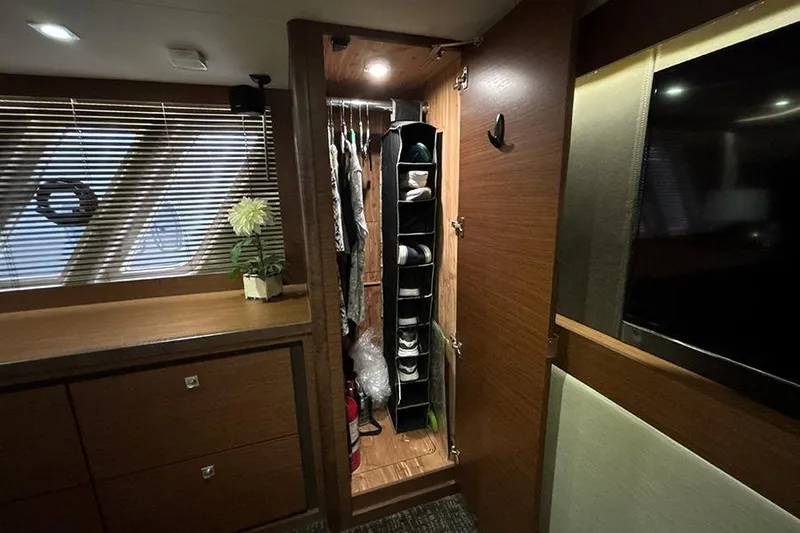 Slide: The Image of Luxurious 2015 Sea Ray 510 Fly yacht interior with closet and elegant wood finish. - 49