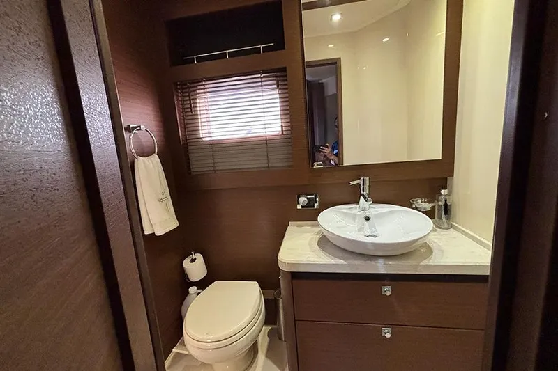 Slide: The Image of Luxurious bathroom in 2015 Sea Ray 510 Fly yacht with modern fixtures and wood accents. - 50