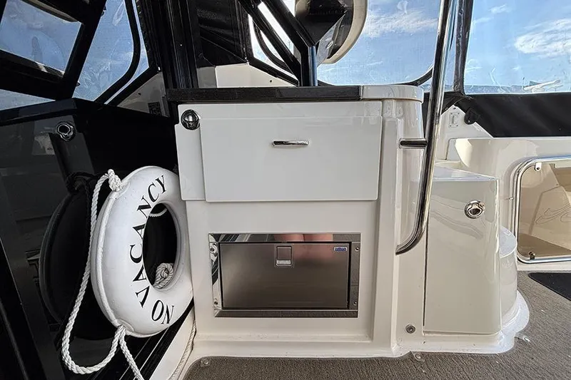 Slide: The Image of 2015 Sea Ray 510 Fly yacht interior with "No Vacancy" life preserver and storage compartment. - 8