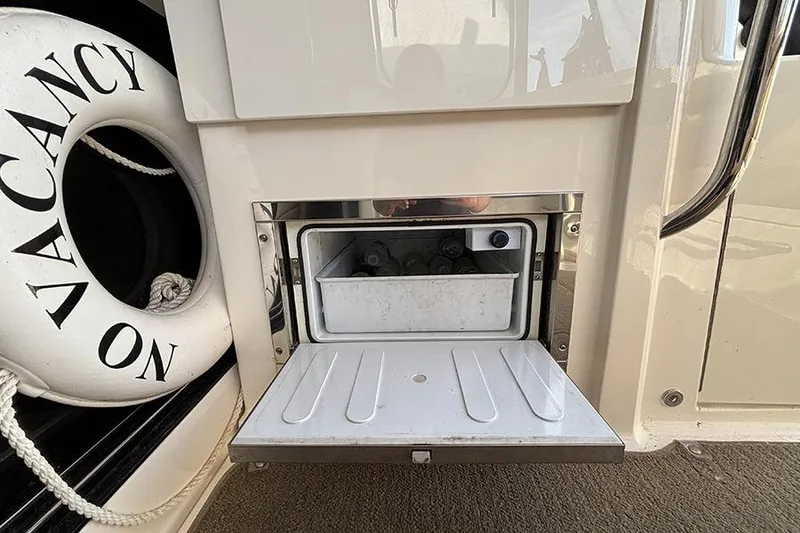 Slide: The Image of 2015 Sea Ray 510 Fly yacht with open storage compartment and life preserver. - 9