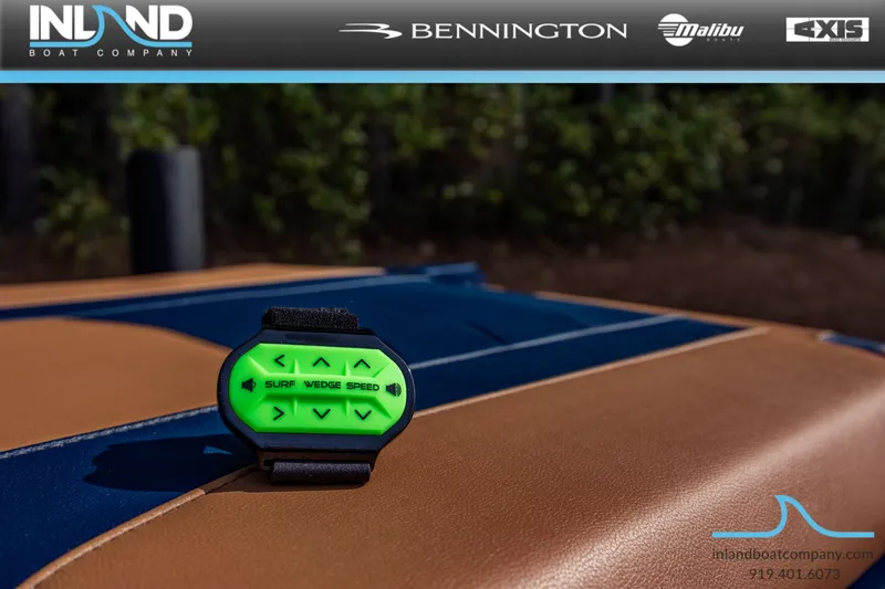 Slide: The Image of Malibu Wakesetter 23 LSV 2026 with green control device on leather seat. - 11
