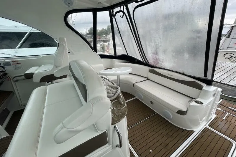 Slide: The Image of 2008 Cruisers Yachts 390 Express Coupe interior with white seating and wood flooring. - 11