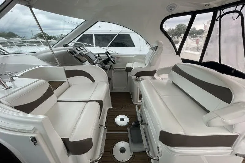 Slide: The Image of 2008 Cruisers Yachts 390 Express Coupe interior with white seating and modern helm. - 13
