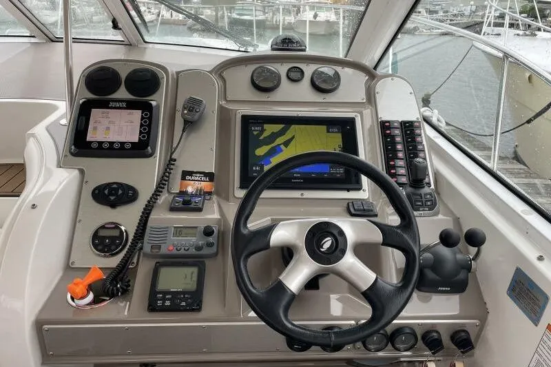 Slide: The Image of Cockpit of 2008 Cruisers Yachts 390 Express Coupe with navigation equipment and steering wheel. - 14