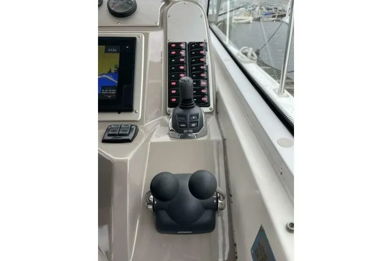Slide: The Image of Control panel of 2008 Cruisers Yachts 390 Express Coupe with joystick and navigation display. - 18