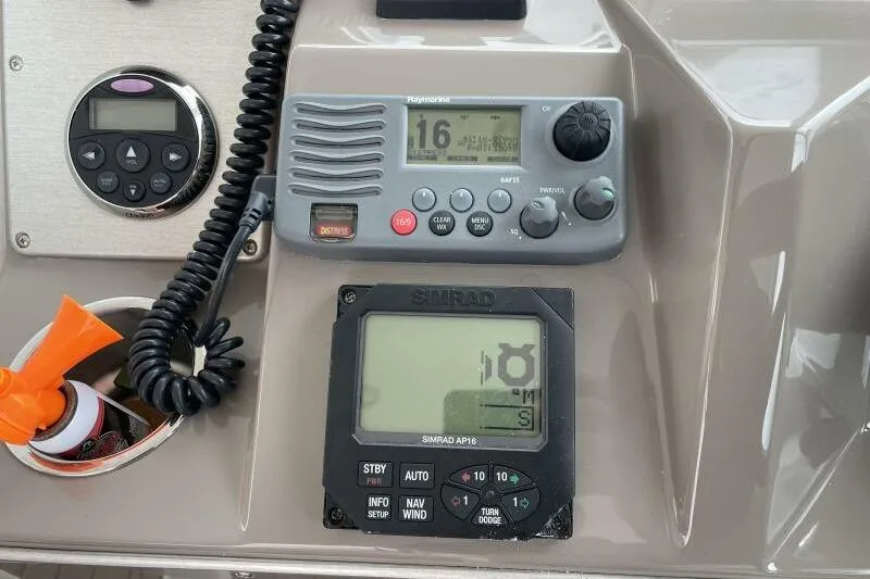 Slide: The Image of Control panel of 2008 Cruisers Yachts 390 Express Coupe with navigation and communication equipment. - 19