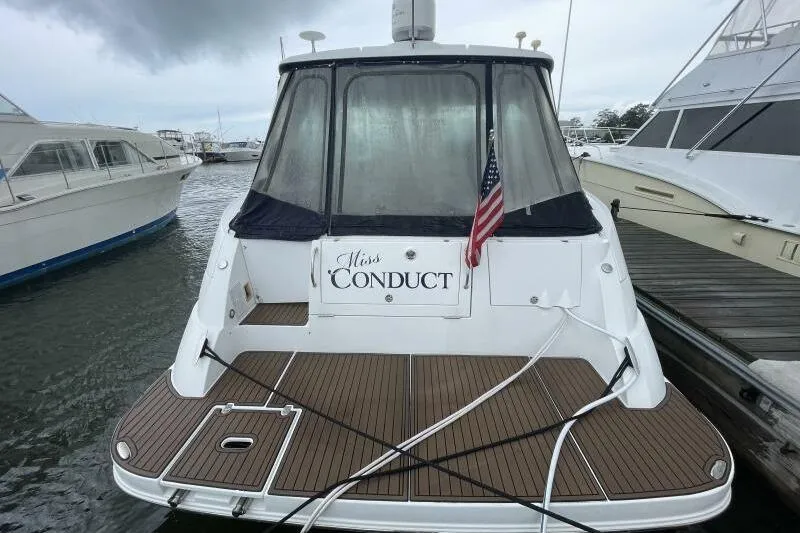 Slide: The Image of 2008 Cruisers Yachts 390 Express Coupe docked, rear view with American flag. - 2