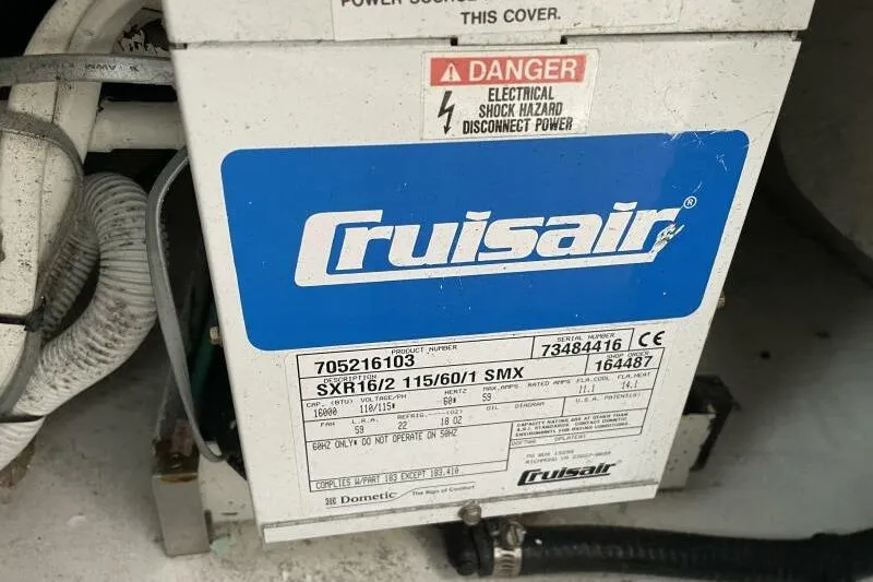 Slide: The Image of Cruisair unit on 2008 Cruisers Yachts 390 Express Coupe, showing electrical warning label. - 24