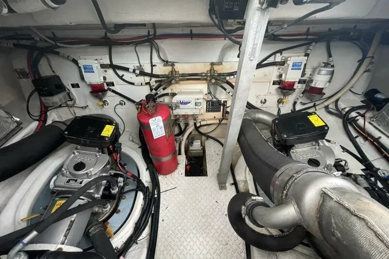 Slide: The Image of Engine room of 2008 Cruisers Yachts 390 Express Coupe with visible machinery and fire extinguisher. - 29