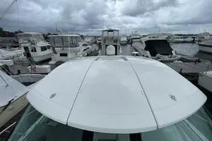 Slide: The Image of 2008 Cruisers Yachts 390 Express Coupe docked among other boats under cloudy skies. - 3