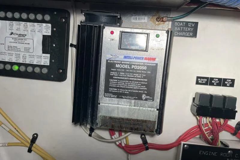 Slide: The Image of Cruisers Yachts 390 Express Coupe 2008 electronic engine room panel and battery charger. - 33