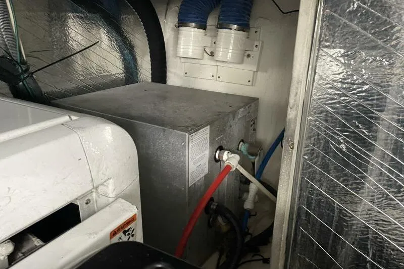 Slide: The Image of Engine room of 2008 Cruisers Yachts 390 Express Coupe with visible piping and insulation. - 35