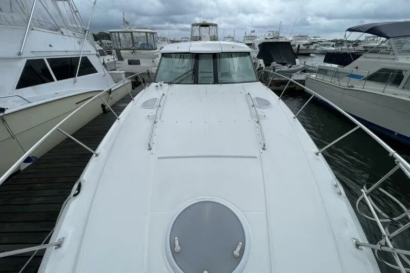 Slide: The Image of 2008 Cruisers Yachts 390 Express Coupe docked among other boats. - 4