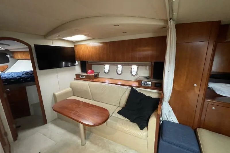 Slide: The Image of Interior of 2008 Cruisers Yachts 390 Express Coupe with cozy seating and wooden cabinetry. - 43