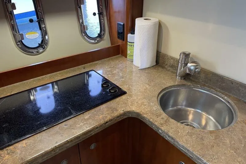 Slide: The Image of 2008 Cruisers Yachts 390 Express Coupe kitchen with stove and sink. - 47
