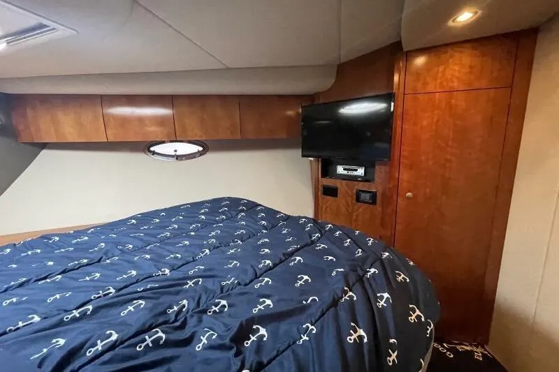 Slide: The Image of Luxurious cabin interior of 2008 Cruisers Yachts 390 Express Coupe with anchor-themed bedding. - 49