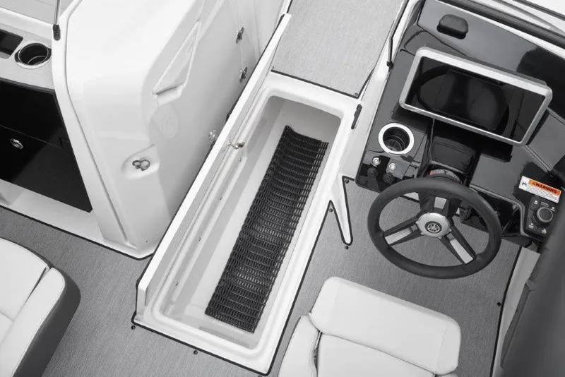 Slide: The Image of 2026 Yamaha Boats AR250 interior with steering wheel and storage compartment. - 6
