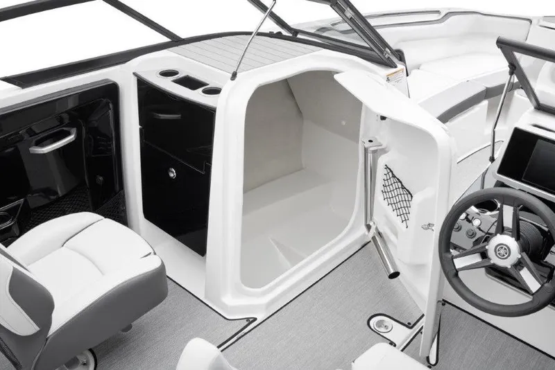 Slide: The Image of 2026 Yamaha Boats AR250 interior with open storage compartment and modern steering console. - 7