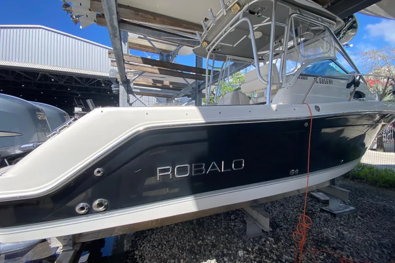 Slide: The Image of 2007 Robalo R265 Walkaround boat on a lift, side view. - 11