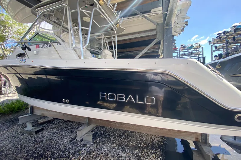 Slide: The Image of 2007 Robalo R265 Walkaround boat on dry dock, side view. - 12