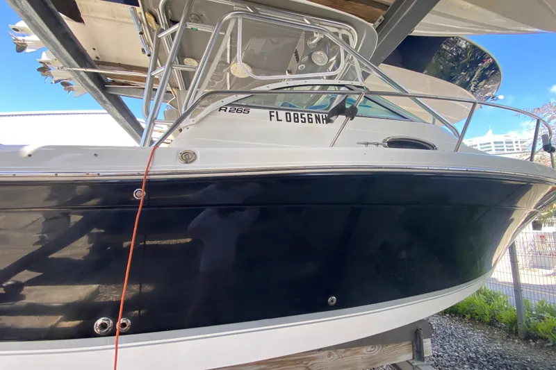 Slide: The Image of 2007 Robalo R265 Walkaround boat on a lift, side view. - 13