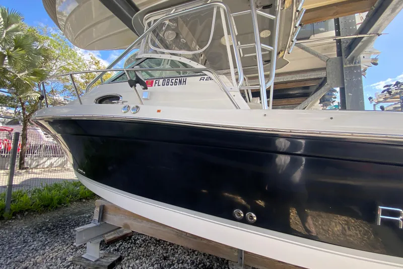 Slide: The Image of 2007 Robalo R265 Walkaround boat on display, featuring sleek black and white design. - 14