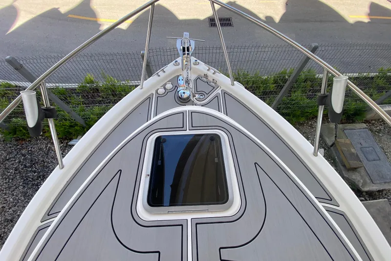 Slide: The Image of 2007 Robalo R265 Walkaround boat deck with hatch and railing. - 16