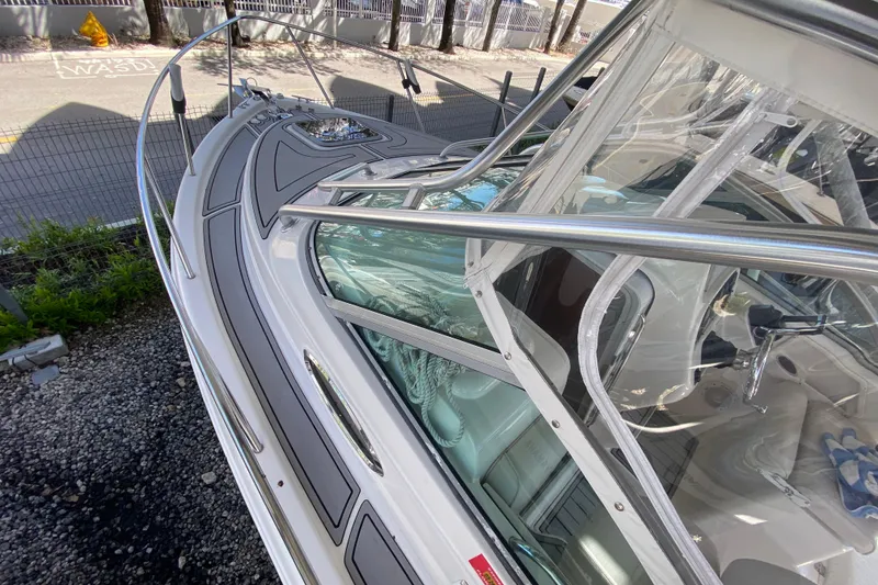 Slide: The Image of 2007 Robalo R265 Walkaround boat deck with stainless steel railings and clear windshield. - 18
