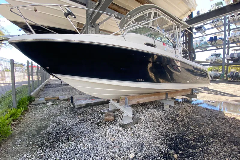 Slide: The Image of 2007 Robalo R265 Walkaround boat on dry dock, side view. - 2