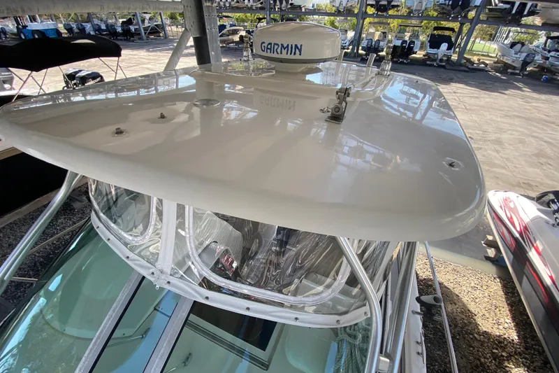 Slide: The Image of 2007 Robalo R265 Walkaround boat with Garmin radar, docked in a marina. - 21