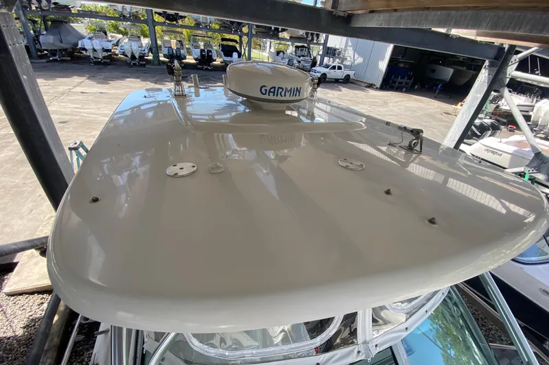 Slide: The Image of 2007 Robalo R265 Walkaround boat with Garmin radar, docked in a marina. - 22